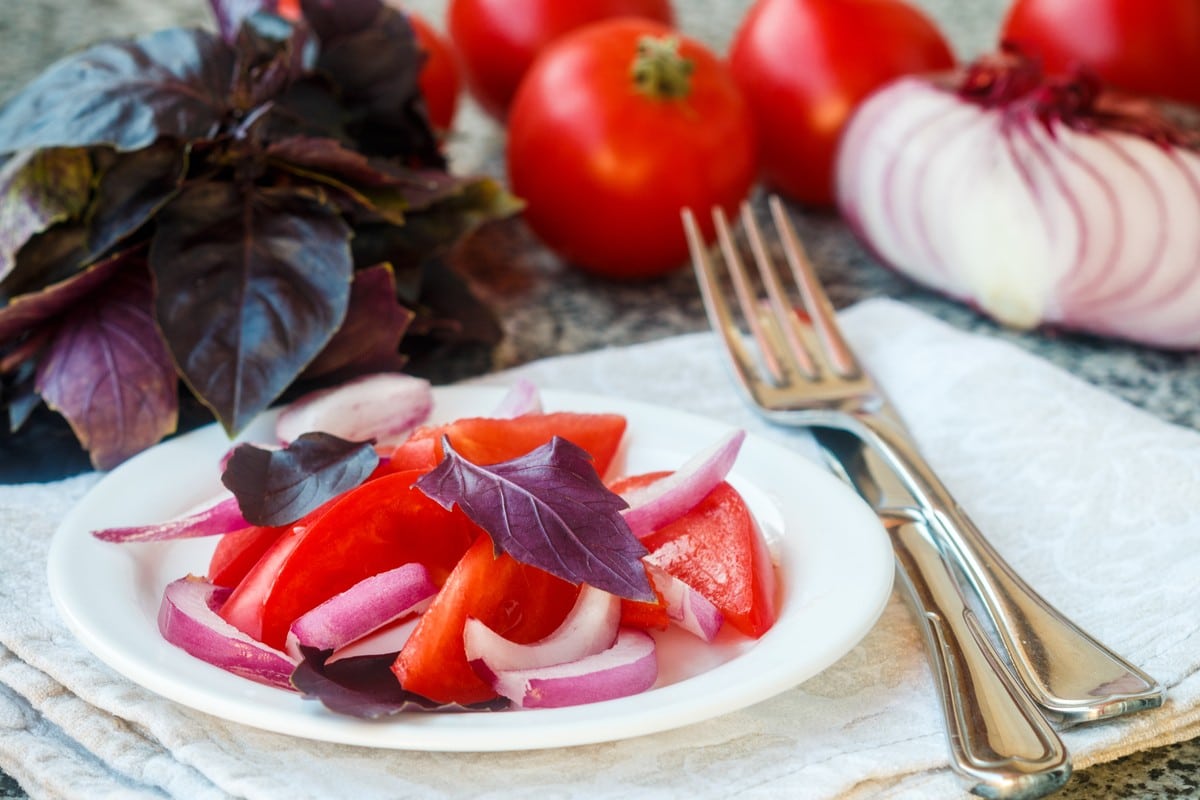 Aromatischer Tomatensalat mit rotem Basilikum und Zwiebeln