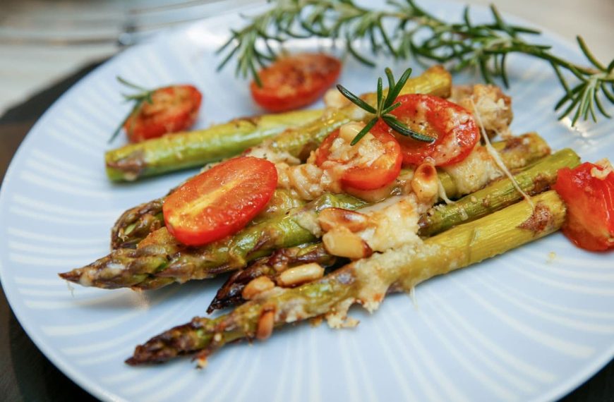 Grüner Spargel mit Tomaten, Parmesan und Pinienkernen im Backofen