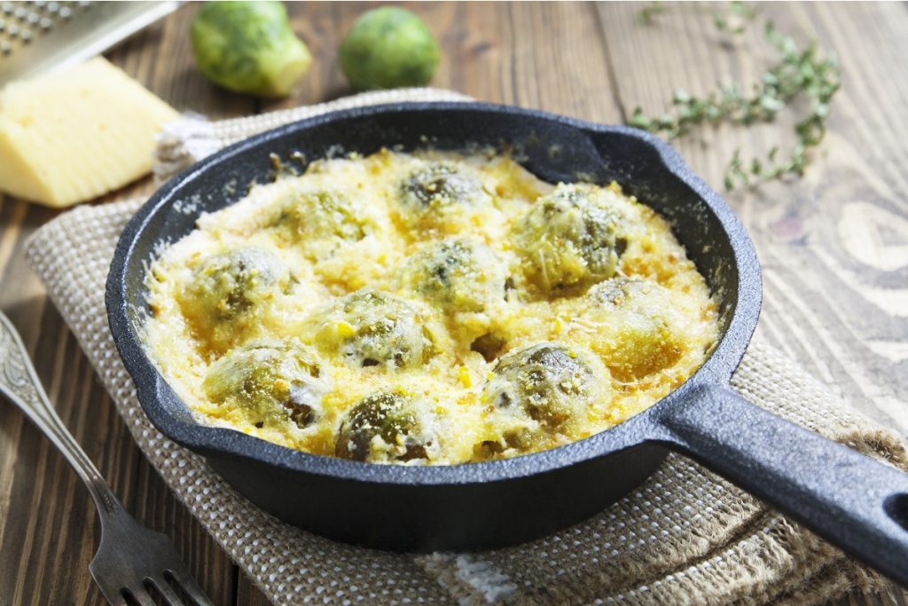 Zarter Rosenkohl mit Milchsoße und Käse im Ofen