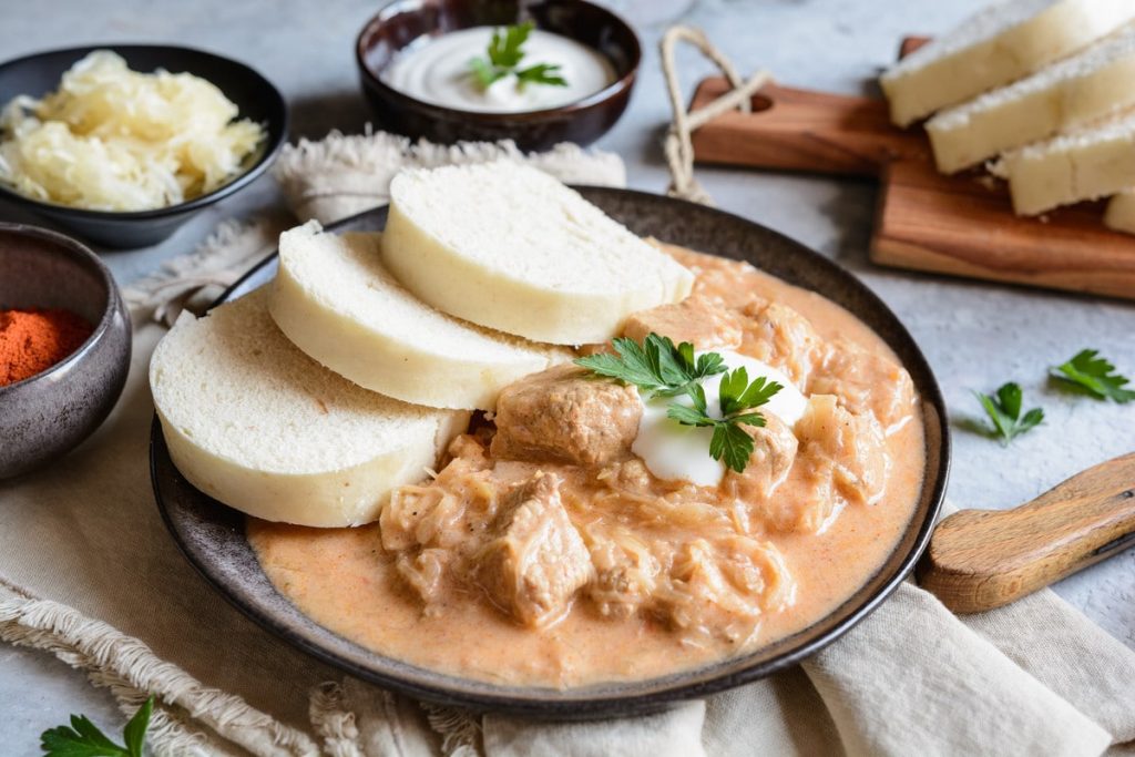 Zarter Schweinegulasch mit Tomaten und Zwiebeln im Ofen
